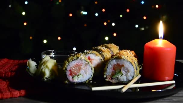 Sushi Blinking Christmas Lights New Year Still Life Burning Candle — Stock Video
