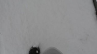 İlk kardaki ayak sesleri. Karlı bir yolda yürüyen bir adam.