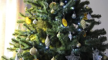 Toys and lanterns on the spruce branches. Christmas tree. New Year holiday.