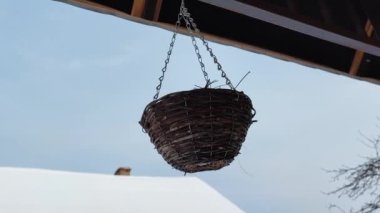 Zincirli çiçekler için hasır sepet. Kışın terasta saksılar asılı..