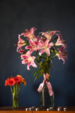 Beautiful bouquet of flowers. Lilies on a dark background. Background. Texture.