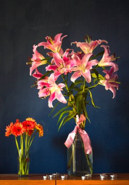 Beautiful bouquet of flowers. Lilies on a dark background. Background. Texture.