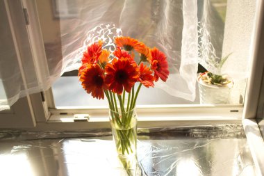 A beautiful bouquet of flowers on the window. Lilies on the window. Background. Texture.
