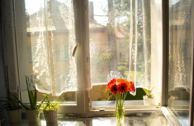 A beautiful bouquet of flowers on the window. Lilies on the window. Background. Texture.