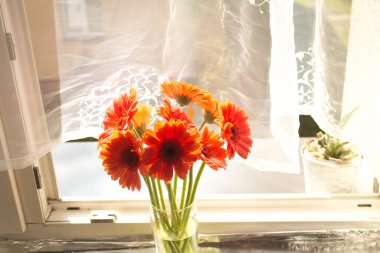 A beautiful bouquet of flowers on the window. Lilies on the window. Background. Texture.