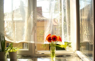 A beautiful bouquet of flowers on the window. Lilies on the window. Background. Texture.