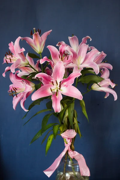Beautiful bouquet of flowers. Lilies on a dark background. Background. Texture.