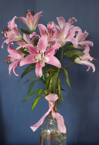 Beautiful bouquet of flowers. Lilies on a dark background. Background. Texture.