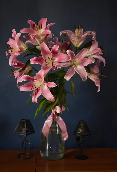 Beautiful bouquet of flowers. Lilies on a dark background. Background. Texture.