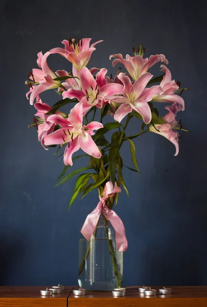 Beautiful bouquet of flowers. Lilies on a dark background. Background. Texture.