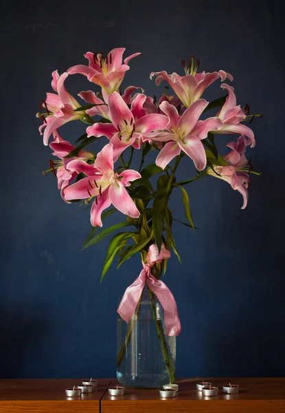 Beautiful bouquet of flowers. Lilies on a dark background. Background. Texture.