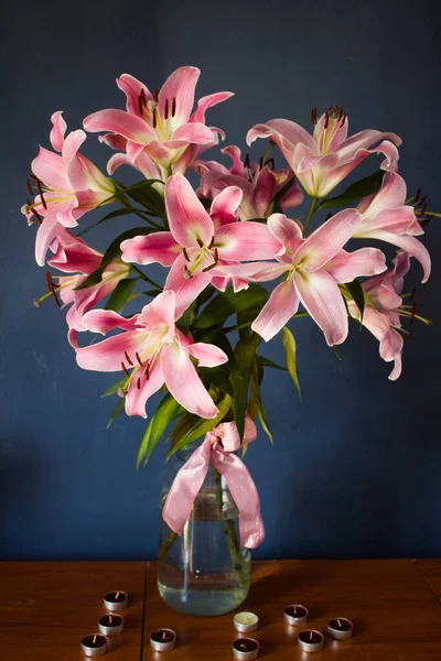 Beautiful bouquet of flowers. Lilies on a dark background. Background. Texture.