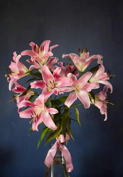 Beautiful bouquet of flowers. Lilies on a dark background. Background. Texture.
