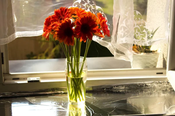 A beautiful bouquet of flowers on the window. Lilies on the window. Background. Texture.
