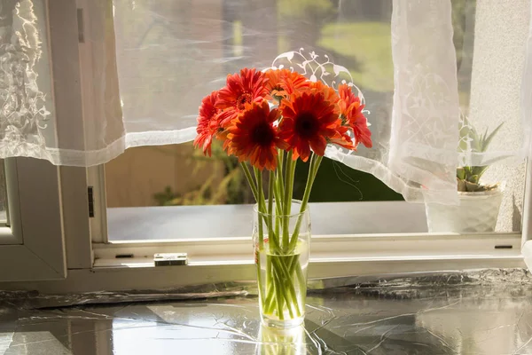 A beautiful bouquet of flowers on the window. Lilies on the window. Background. Texture.