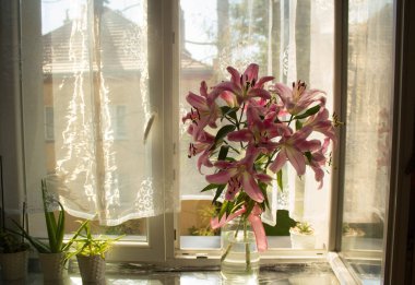 A beautiful bouquet of flowers on the window. Lilies on the window. Background. Texture.