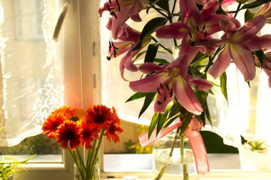 A beautiful bouquet of flowers on the window. Lilies on the window. Background. Texture.