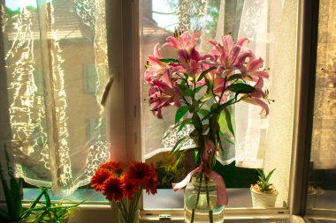 A beautiful bouquet of flowers on the window. Lilies on the window. Background. Texture.