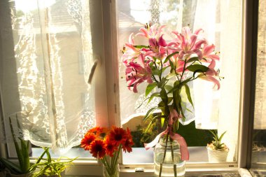 A beautiful bouquet of flowers on the window. Lilies on the window. Background. Texture.