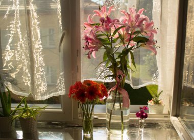 A beautiful bouquet of flowers on the window. Lilies on the window. Background. Texture.