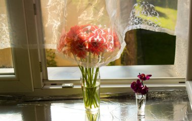 A beautiful bouquet of flowers on the window. Lilies on the window. Background. Texture.