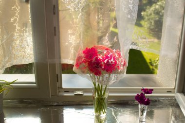 A beautiful bouquet of flowers on the window. Lilies on the window. Background. Texture.