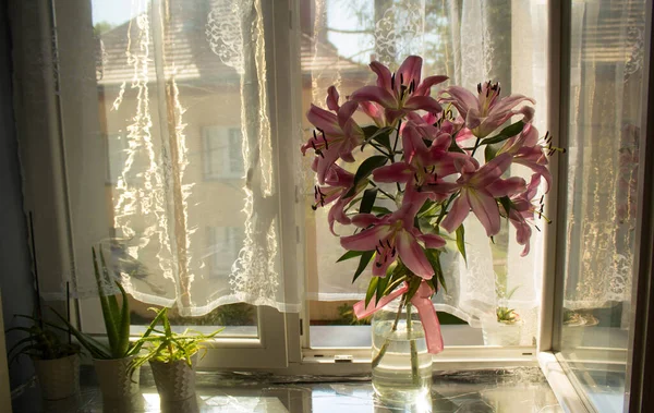 A beautiful bouquet of flowers on the window. Lilies on the window. Background. Texture.