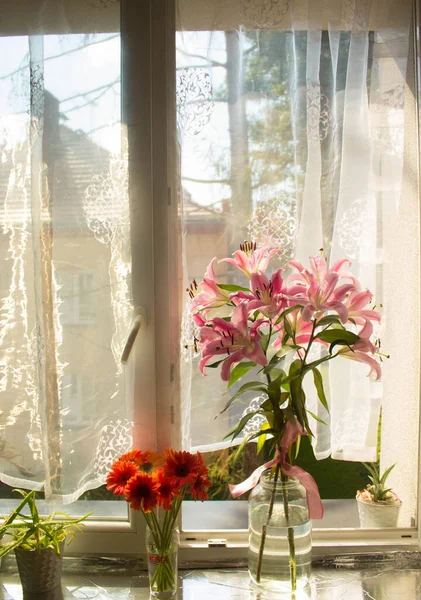 A beautiful bouquet of flowers on the window. Lilies on the window. Background. Texture.