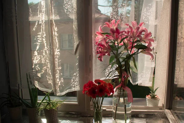 A beautiful bouquet of flowers on the window. Lilies on the window. Background. Texture.