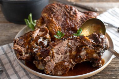 Kahverengi soslu kepçeli hindi budu kızartma. Lezzetli ev yapımı kızarmış bayram yemeği. Kırsal ve ahşap masa arkaplanında yemeye hazır..