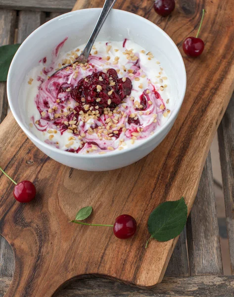 Low carb breakfast bowl with greek yogurt, sour cherry compote and roasted hazelnuts