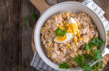 American tuna salad with mayonnaise, eggs, onions and corn. Traditional and homemade cooked 