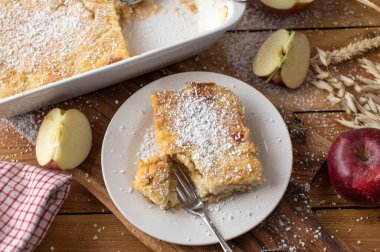 Warm and delicious breakfast casserole dish for autumn and winter season with millet and grated apples. Traditional austrian sweet casserole dish. Served on wooden and rustic table background. Top view