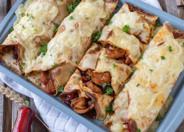 Pancakes with spicy chicken, beans, vegetable filling and cheese topping. Tex mex style food