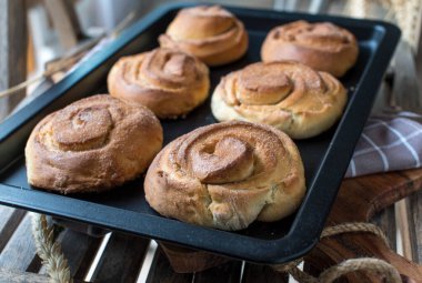 Homemade fresh baked cinnamon rolls with sugar topping. Traditional swedish 