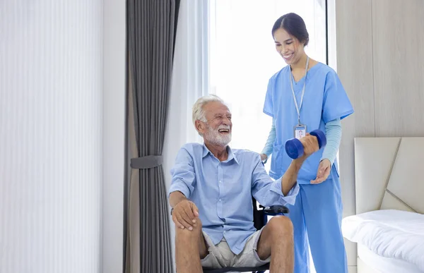 Hospice Nurse Helping Caucasian Man Wheelchair Exercising Muscle Strength Pension — Stockfoto