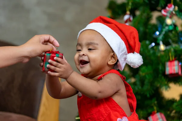 African American Baby Happily Smiling While Receiving Little Gift Box —  Fotos de Stock