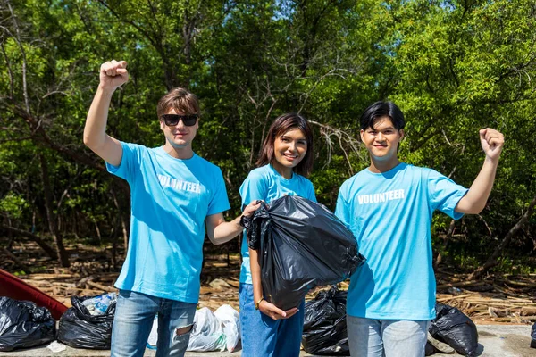 Team of young and diversity volunteer worker group enjoy charitable social work outdoor in cleaning up garbage and waste separation project at mangrove forest