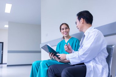 Team of Asian doctor is discussing and brainstorming on patient medical record after diagnosis for precise care plan with experienced senior physician specialist concept