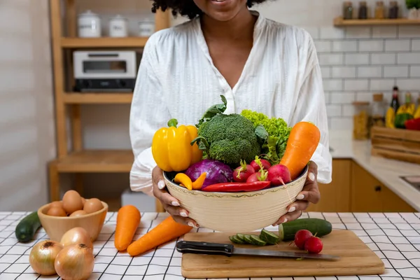 African American housewife is showing variety of organic vegetables to prepare simple and easy southern style salad meal for vegan and vegetarian food concept