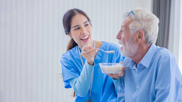 Hospice Nurse Feeding Porridge Food Caucasian Man Pension Retirement Center — Stok fotoğraf