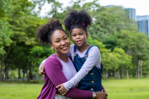 African American Mother Hugging Her Young Daughter While Having Summer — Stok fotoğraf