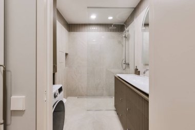 Modern minimalist banyo iç tasarımı mermer taş fayanslar ve haki rengi mobilyalar.