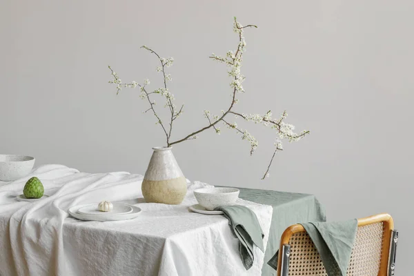 Elegant table setting with cherry brunch in craft vase , cherimoya fruits, garlic in craft ceramic plate on linen tablecloth. Outdoor table setting for summer holiday concept.