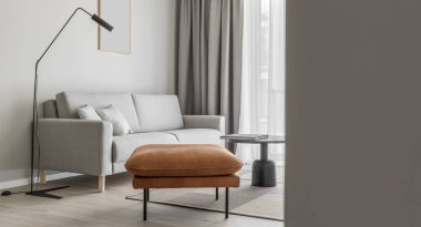 Modern minimalist oturma odası içi gri kanepe, deri koltuk, siyah zarif lamba. Estetik basit iç tasarım konsepti.