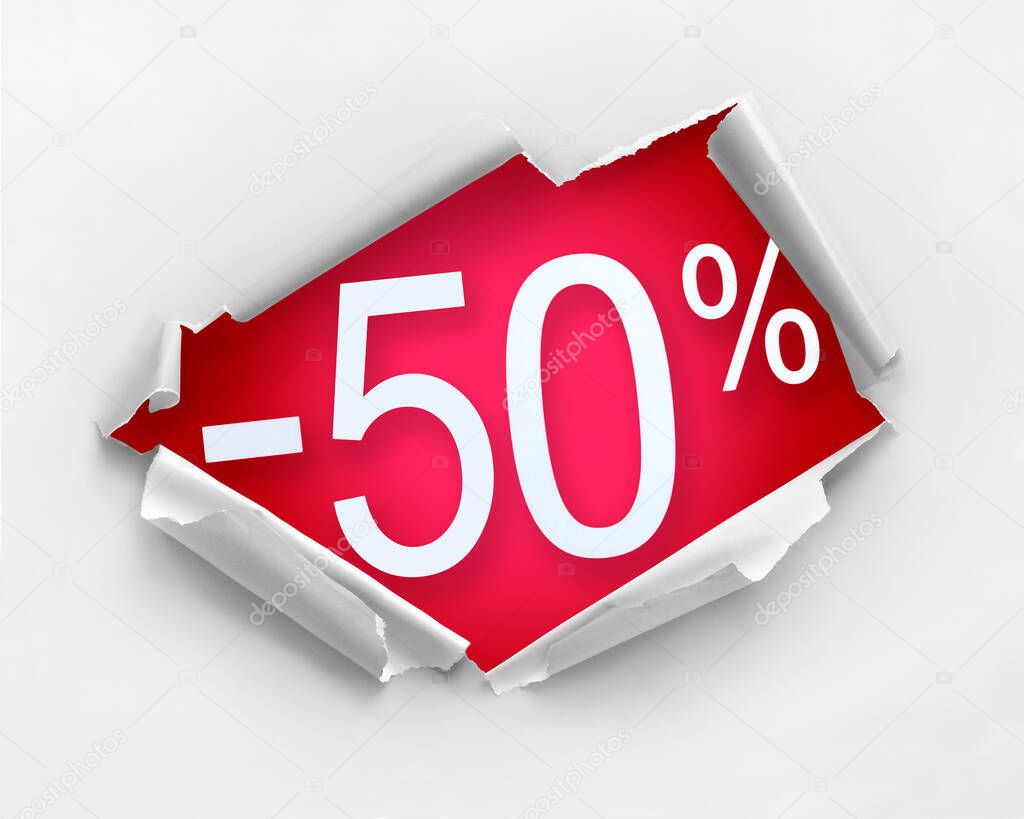 White color hole ripped paper against 50 percent discount message in red color