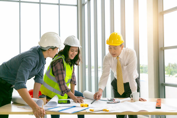 Hands of creative team discussing plan a blueprint of the building.