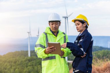 Mühendisler yel değirmeni mühendislerini inceliyor. Rüzgar türbinini kontrol ediyorlar..