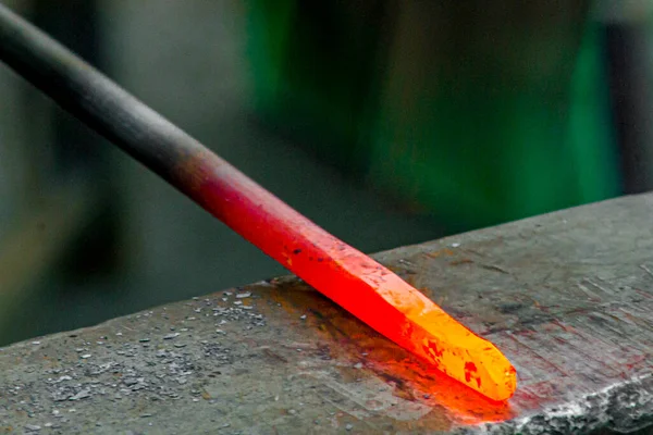 Red hot iron, on the anvil, during the process of forge.