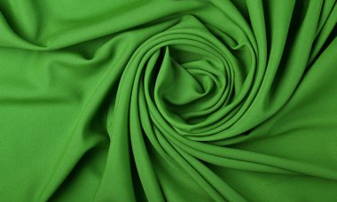 Sarmal şekilli yeşil kıvrımlı kumaşın soyut tekstil arkaplanını kapat, üst görünümü doğrudan yukarıda tut.